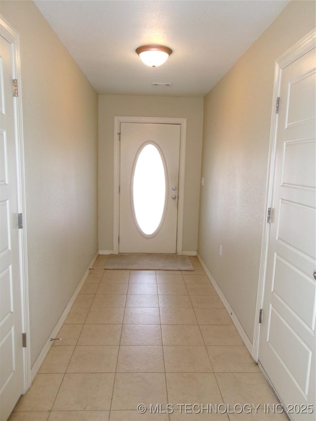 entryway with light tile patterned flooring