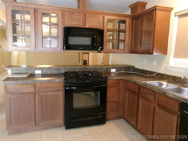 kitchen with light tile patterned floors, black appliances, and sink