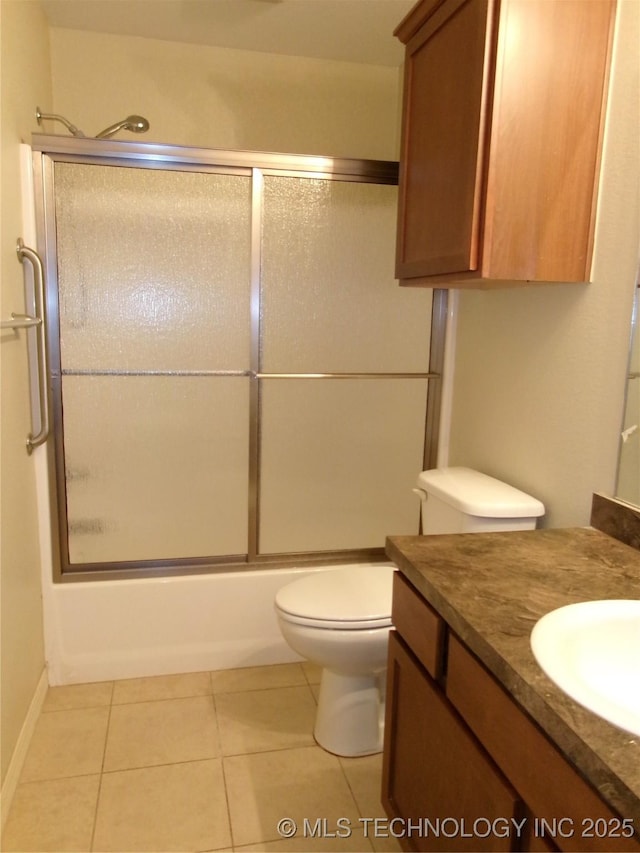 full bathroom featuring toilet, bath / shower combo with glass door, tile patterned floors, and vanity