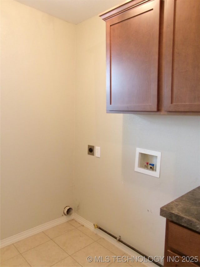 clothes washing area featuring cabinets, hookup for a washing machine, hookup for a gas dryer, hookup for an electric dryer, and light tile patterned floors