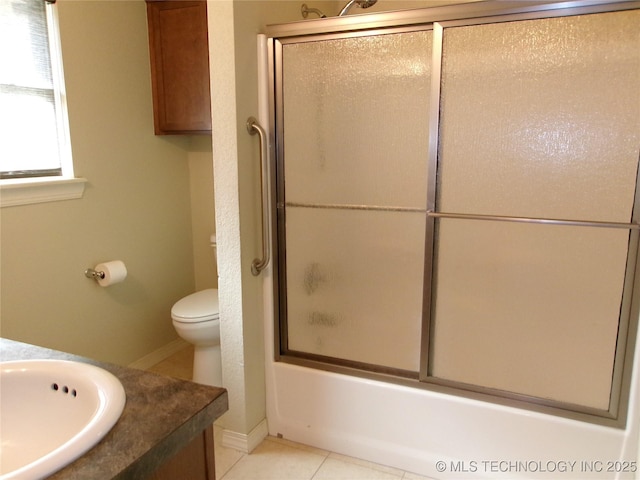 full bathroom with tile patterned flooring, shower / bath combination with glass door, vanity, and toilet