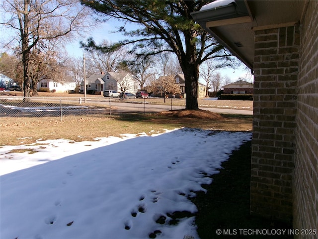 view of yard layered in snow