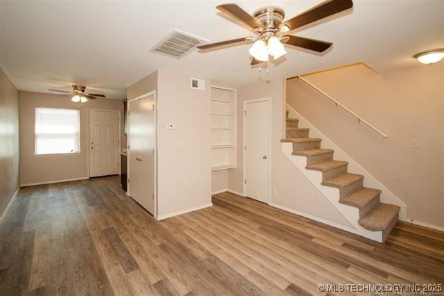 interior space with ceiling fan and wood-type flooring