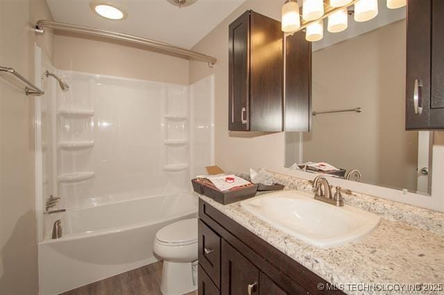 full bathroom with vanity, toilet, wood-type flooring, and tub / shower combination