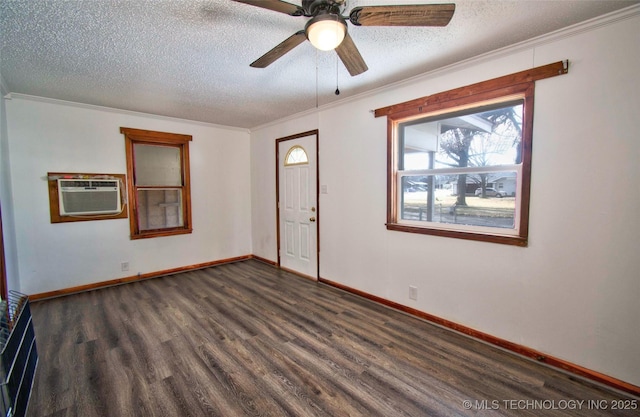 empty room with a wall mounted air conditioner, crown molding, ceiling fan, a textured ceiling, and dark hardwood / wood-style flooring