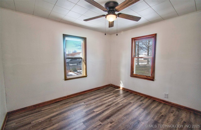 spare room featuring ceiling fan and dark hardwood / wood-style flooring