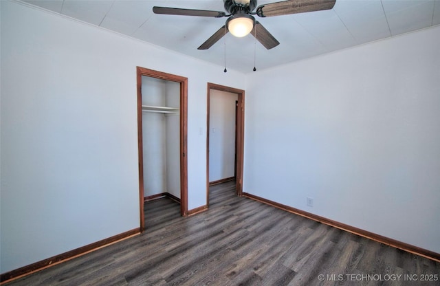 unfurnished bedroom with ceiling fan, dark hardwood / wood-style floors, and a closet