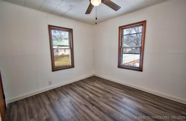 spare room featuring dark hardwood / wood-style flooring, ceiling fan, and a healthy amount of sunlight