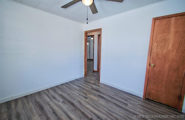 spare room featuring dark hardwood / wood-style floors, ceiling fan, and crown molding