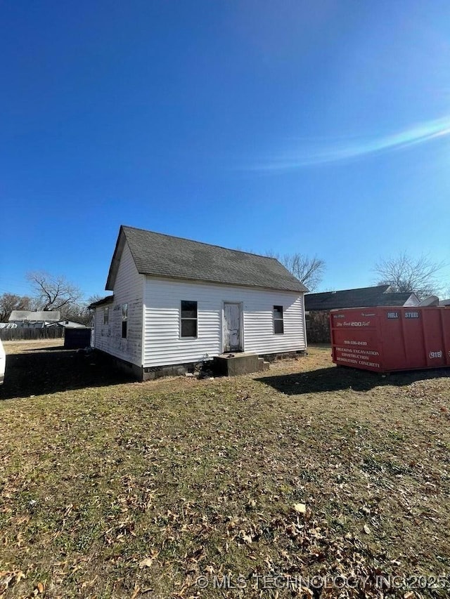 rear view of house with a yard