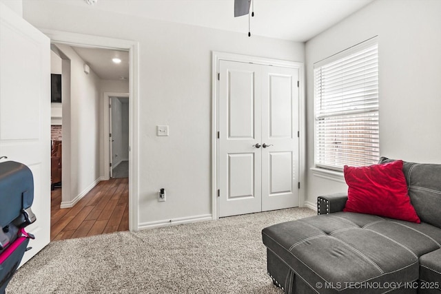 sitting room featuring carpet floors, ceiling fan, and a healthy amount of sunlight