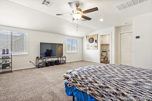 bedroom with ceiling fan, connected bathroom, vaulted ceiling, and carpet floors