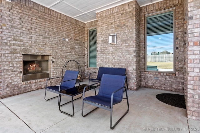 view of patio / terrace featuring an outdoor brick fireplace