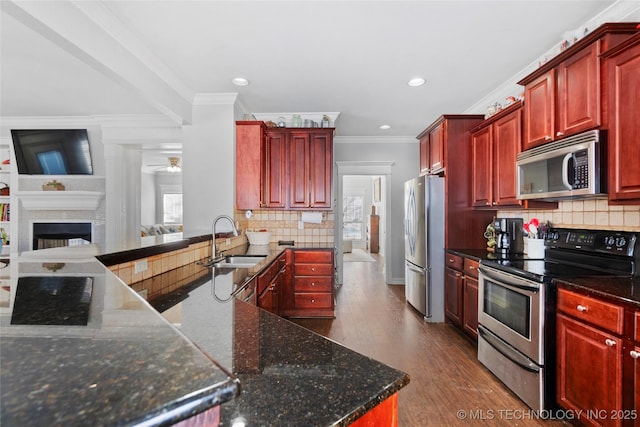 kitchen with crown molding, appliances with stainless steel finishes, backsplash, and sink