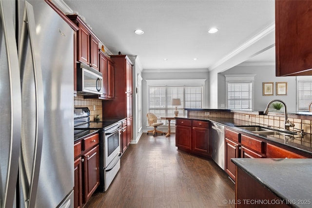 kitchen with stainless steel appliances, sink, ornamental molding, decorative backsplash, and dark hardwood / wood-style floors