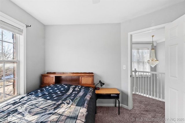 bedroom featuring multiple windows and carpet