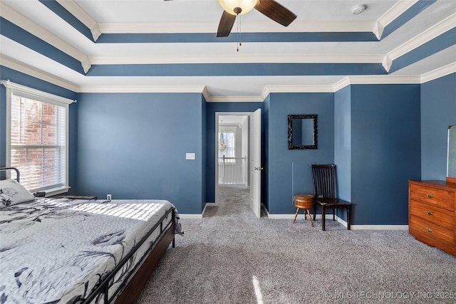 carpeted bedroom featuring ornamental molding, ceiling fan, and a tray ceiling