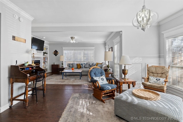 living room with ceiling fan with notable chandelier, dark wood-type flooring, crown molding, and plenty of natural light