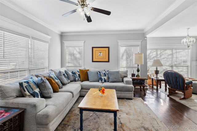 living room featuring ceiling fan with notable chandelier, dark hardwood / wood-style flooring, and ornamental molding