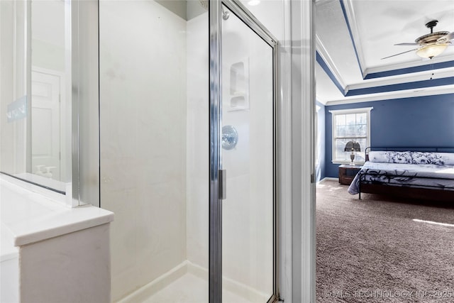 bathroom with ornamental molding, ceiling fan, and an enclosed shower