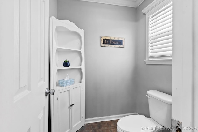 bathroom with toilet and crown molding