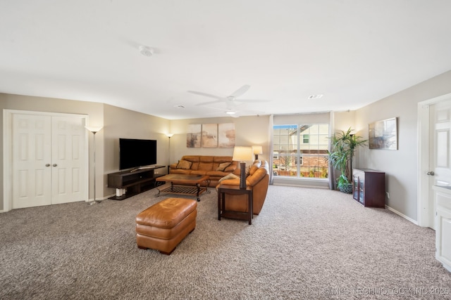 carpeted living room with ceiling fan