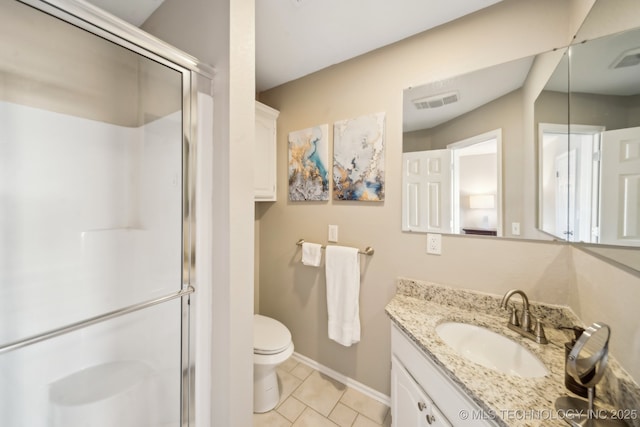 bathroom featuring vanity, tile patterned flooring, toilet, and a shower with shower door