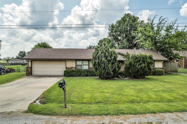 ranch-style home featuring a garage and a front lawn