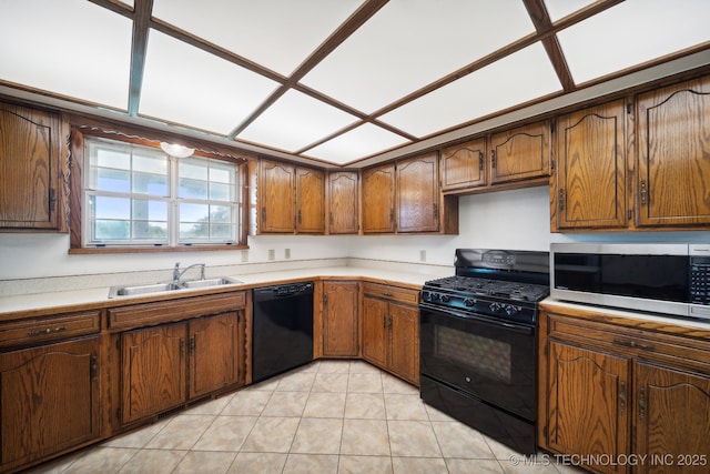 kitchen featuring sink, light tile patterned floors, and black appliances