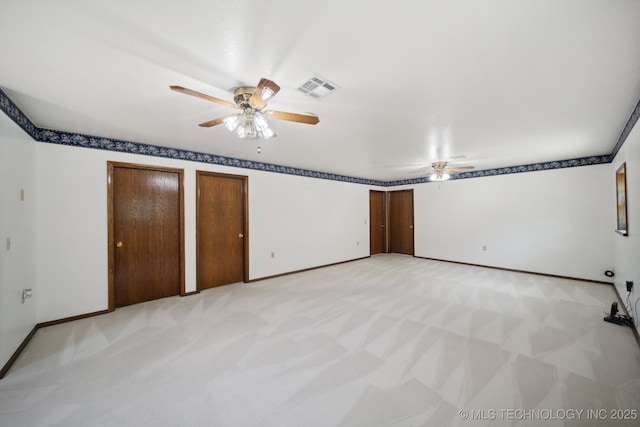 unfurnished bedroom with two closets, ceiling fan, and light colored carpet