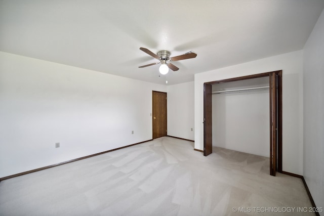 unfurnished bedroom featuring a closet, ceiling fan, and light colored carpet