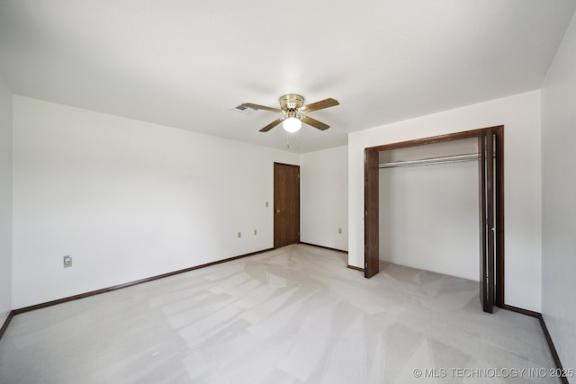 unfurnished bedroom featuring a closet, ceiling fan, and light colored carpet