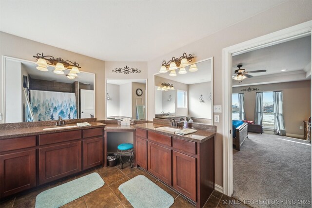 bathroom featuring ceiling fan, a wealth of natural light, and vanity