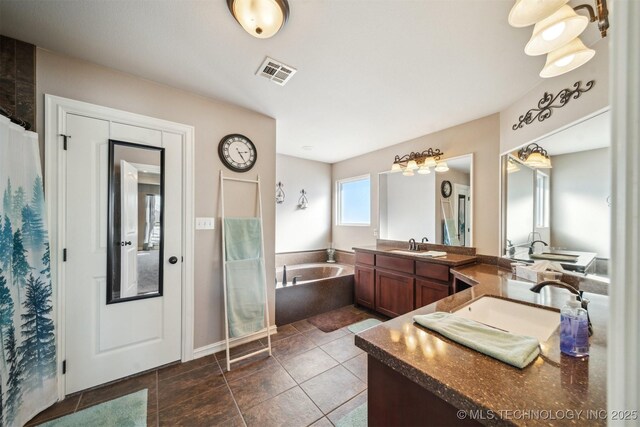 bathroom featuring tile patterned floors, vanity, and a tub