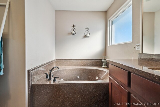 bathroom with a bath and vanity