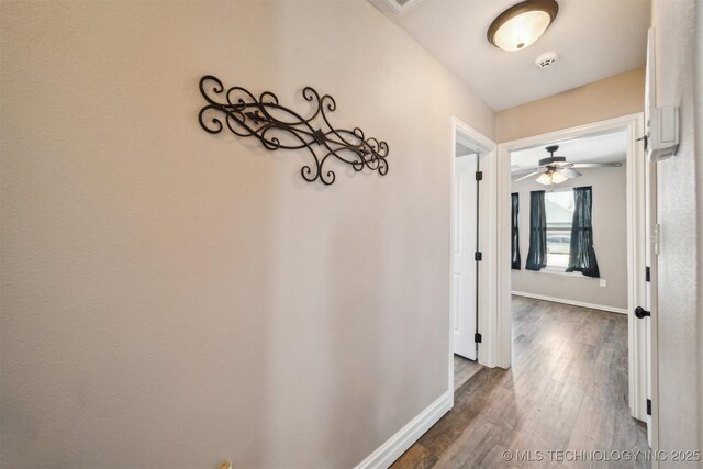 hallway with dark hardwood / wood-style floors