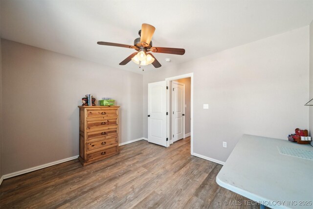 office area with ceiling fan and dark hardwood / wood-style floors