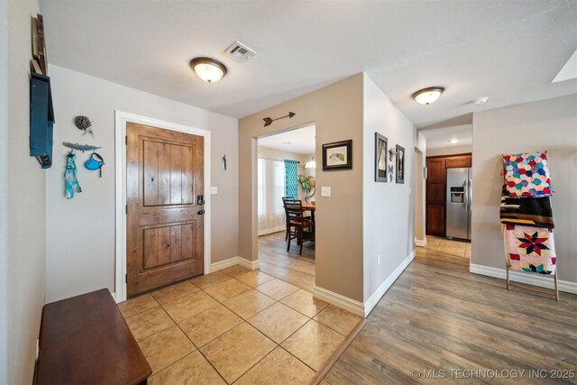 foyer with light hardwood / wood-style floors