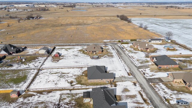 snowy aerial view featuring a rural view