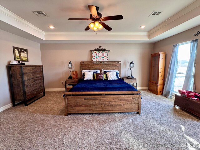 carpeted bedroom with a raised ceiling, ceiling fan, and crown molding