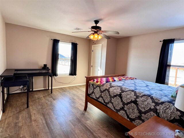 bedroom featuring ceiling fan and dark hardwood / wood-style flooring