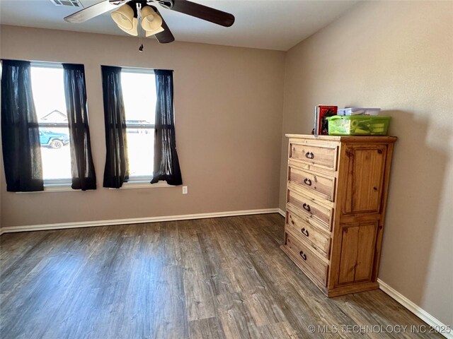 unfurnished bedroom with ceiling fan and dark hardwood / wood-style flooring