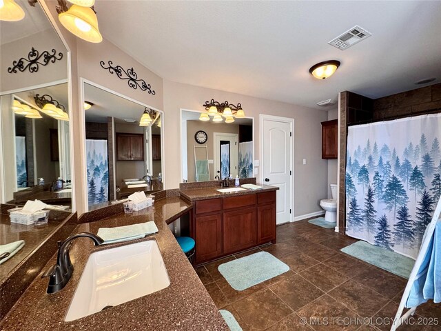 bathroom with walk in shower, vanity, and toilet