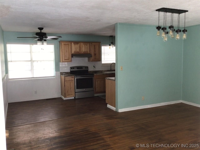 kitchen with stainless steel range with electric cooktop, sink, ceiling fan, hanging light fixtures, and dark hardwood / wood-style flooring