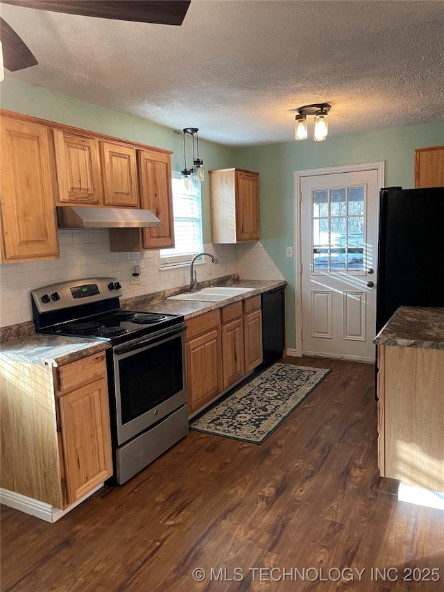 kitchen featuring sink, a textured ceiling, pendant lighting, black appliances, and dark wood-type flooring