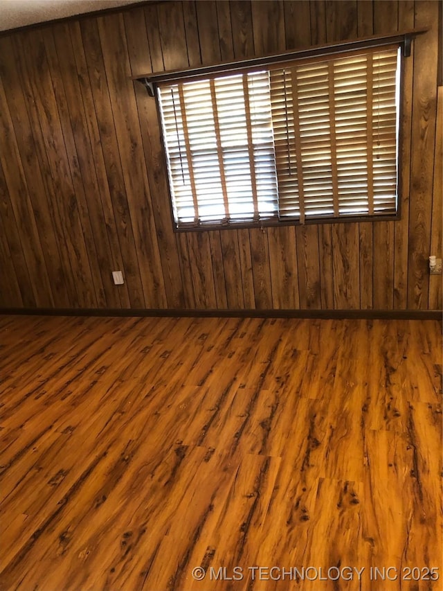 unfurnished room with hardwood / wood-style floors