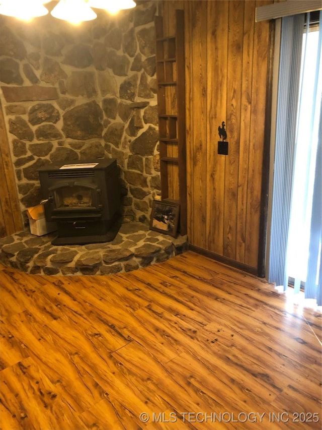 details featuring hardwood / wood-style flooring and a wood stove