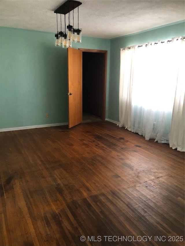 3031 N 430, Pryor, OK 74361 - empty room featuring baseboards and dark wood-style flooring
