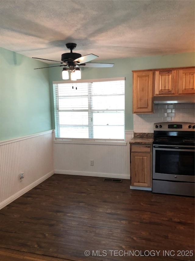 3031 N 430, Pryor, OK 74361 - kitchen with dark wood-style flooring, under cabinet range hood, wainscoting, and stainless steel electric stove