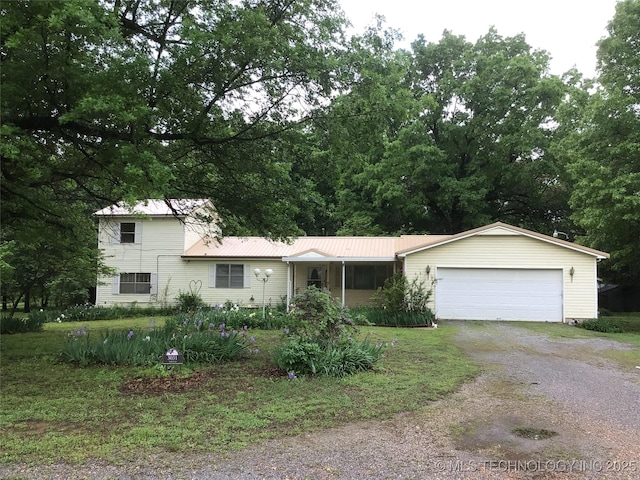 3031 N 430, Pryor, OK 74361 - tri-level home featuring a garage, driveway, and metal roof